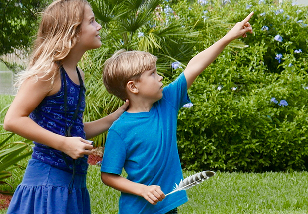 A young girl and a young boy outside